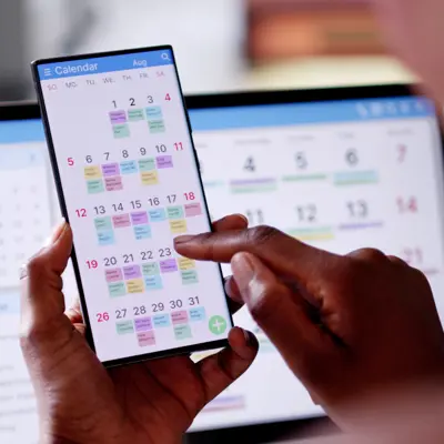 This is a photo of a person looking at their online calendar on their phone. 